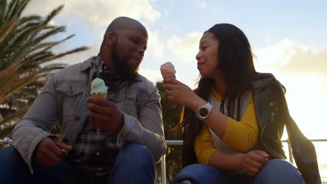 disabled woman feeding ice cream to man on a sunny day 4k