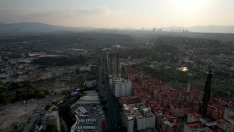 backwards-drone-shot-of-western-Mexico-city-and-huge-residential-buildings-in-a-very-polluted-day