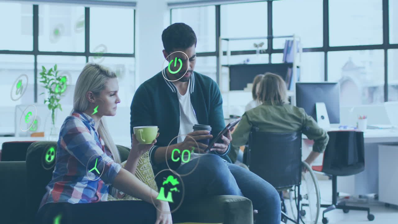 Animation of ecology icons over disabled and diverse colleagues discussing work in office