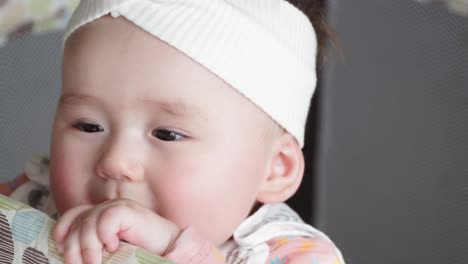 The-face-of-Baby-Girl-Standing-In-Her-Crib---high-angle,-face-close-up