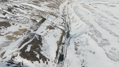 snowy landscape canyons of glacier valley, jokuldalur in east-iceland - aerial