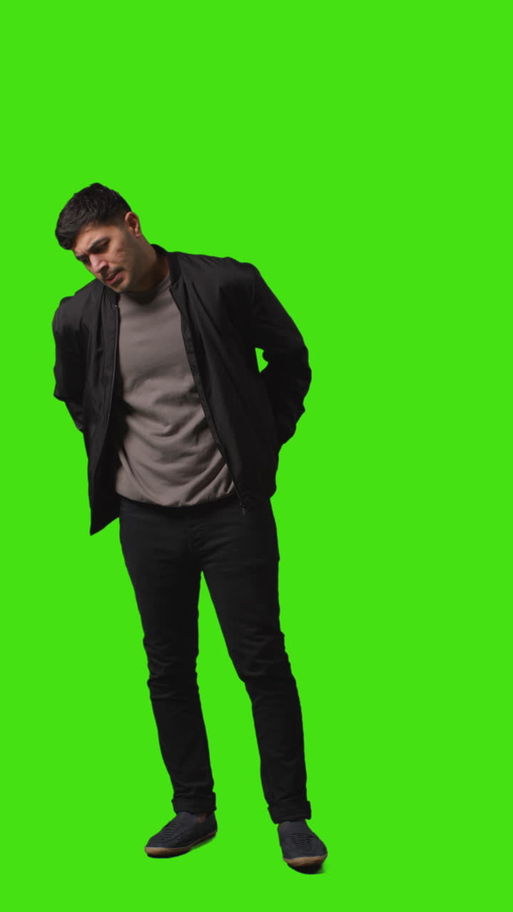 Vertical Video Full Length Portrait Shot Of Worried Or Stressed Looking Man Standing Against Green Screen 4