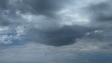 grey clouds float in the sky. low angle view at the dramatic cloudscape covering the sky