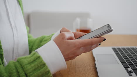 woman hands texting mobile phone message room close up. lady typing smartphone