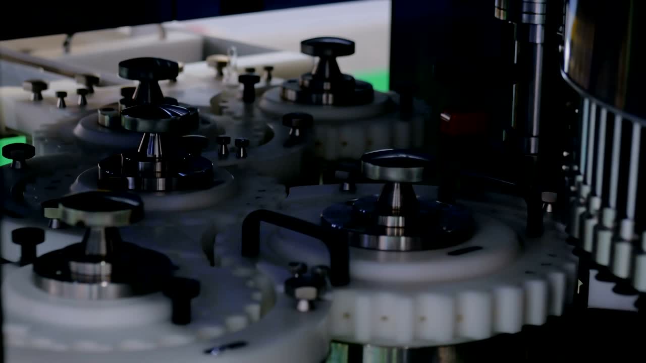 Rotating white gears inside laboratory automatic inspection machine