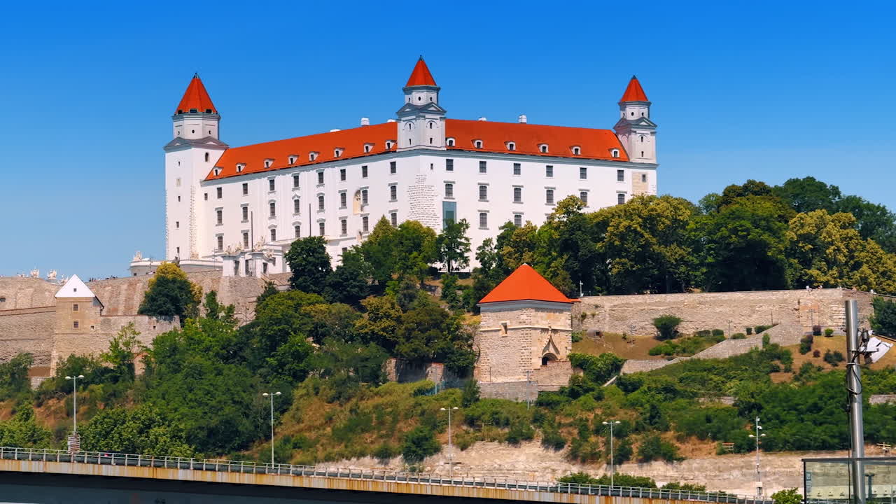 Stunning Bratislava Castle in the greenery at the backdrop of blue sky. Famous landmark of Slovakia
