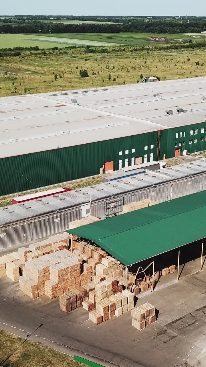 Aerial view of large modern warehouses in the industrial complex Vertical video