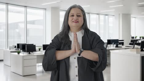 Happy-Indian-senior-female-lawyer-doing-greetings-and-Namaste