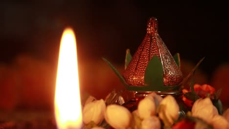 small light burning on a table decorated for pooja