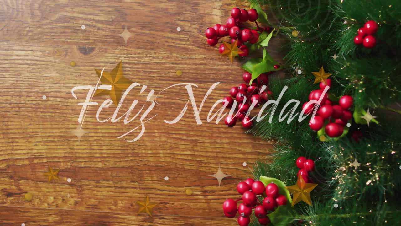 Feliz Navidad text animation over Christmas decorations with holly and pine branches