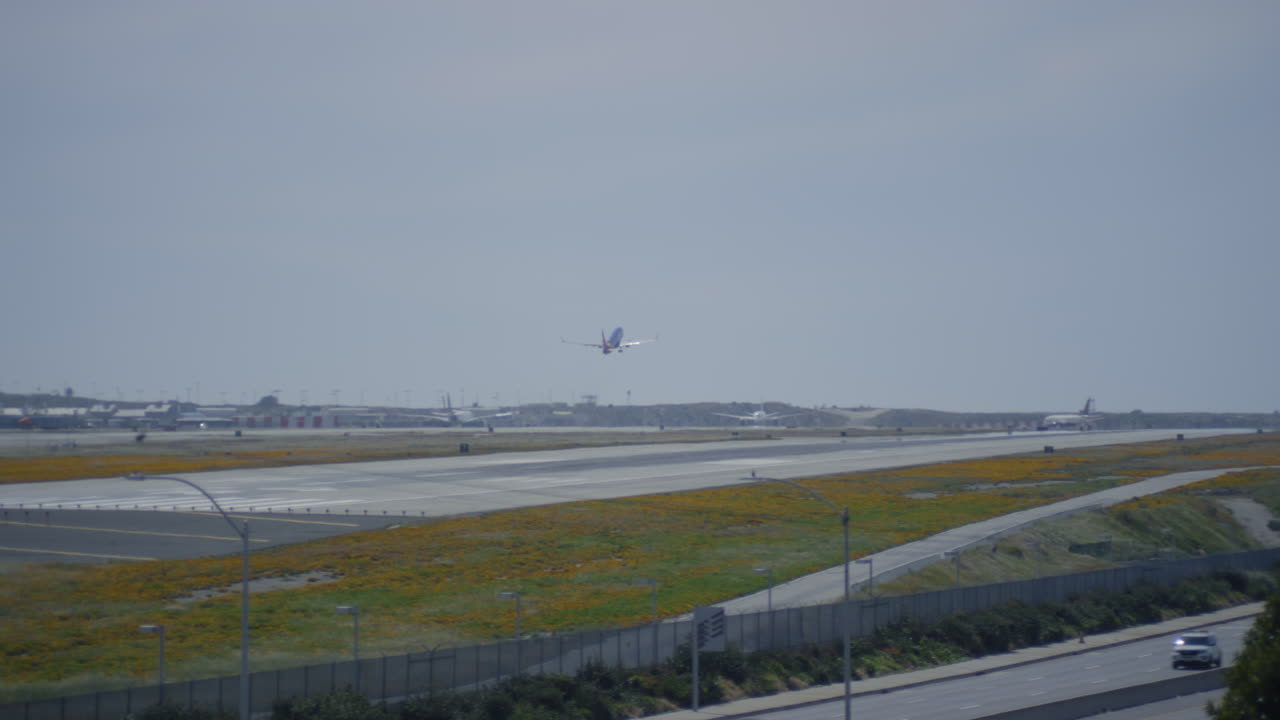 Los Angeles airport airfield. Plane is taking off from runway during the day