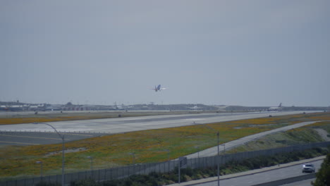 los angeles airport airfield. plane is taking off from runway during the day