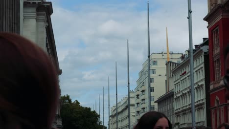 people walking near historic london buildings