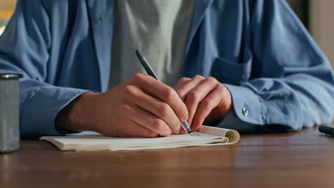 person writing in a notebook