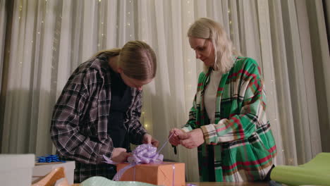 mother and son wrapping presents together