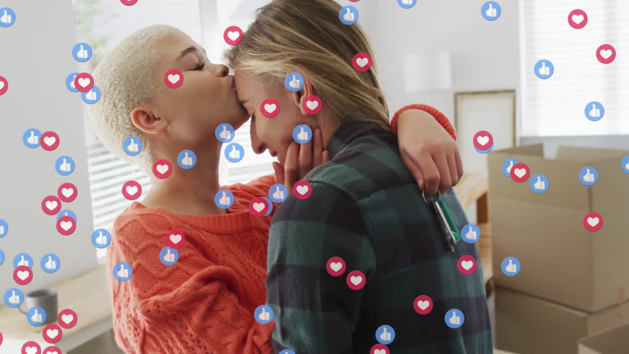 Couple embracing in new apartment, showing technology theme with floating heart and thumbs-up icons