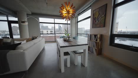 modern kitchen table located in a downtown minneapolis condo building with large windows and cars going by outside