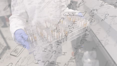 chemical formulas animation over scientist handling test tubes in laboratory