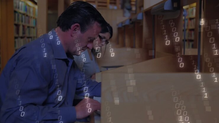 Man and woman studying at carrels, binary code streaming across desks merging study and technology