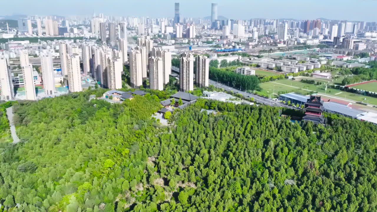 Aerial View of a City Blending Modern High-rises, Lush Forests, and Traditional Architecture