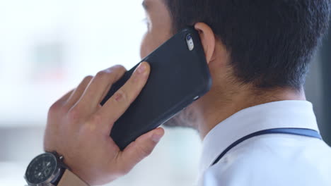 business man talking on a phone call in an office
