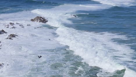top down drone perspective of rolling ocean waves in constant motion