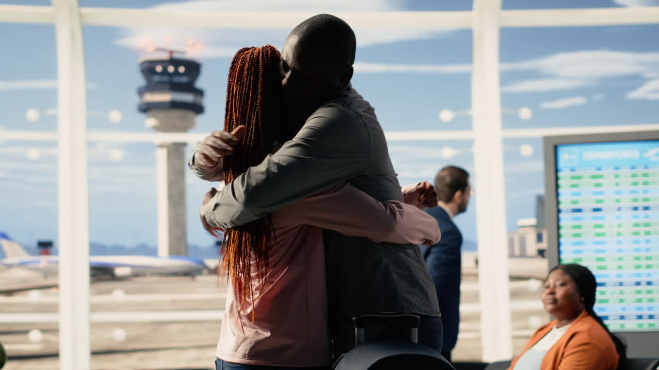 Teenager traveling alone, father hugging as goodbye, airport terminal lounge