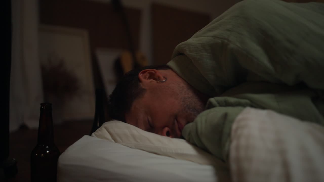 Man Sleeping Uncomfortably in a Bed at Night