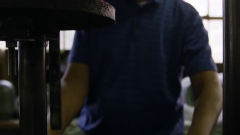 mixed race man working at a hat factory