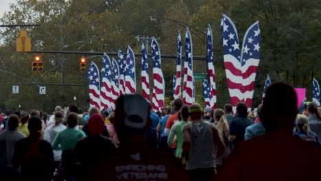 columbus ohio marathon 2019 runners moving away running west on broad street in slow motion with american flags in background