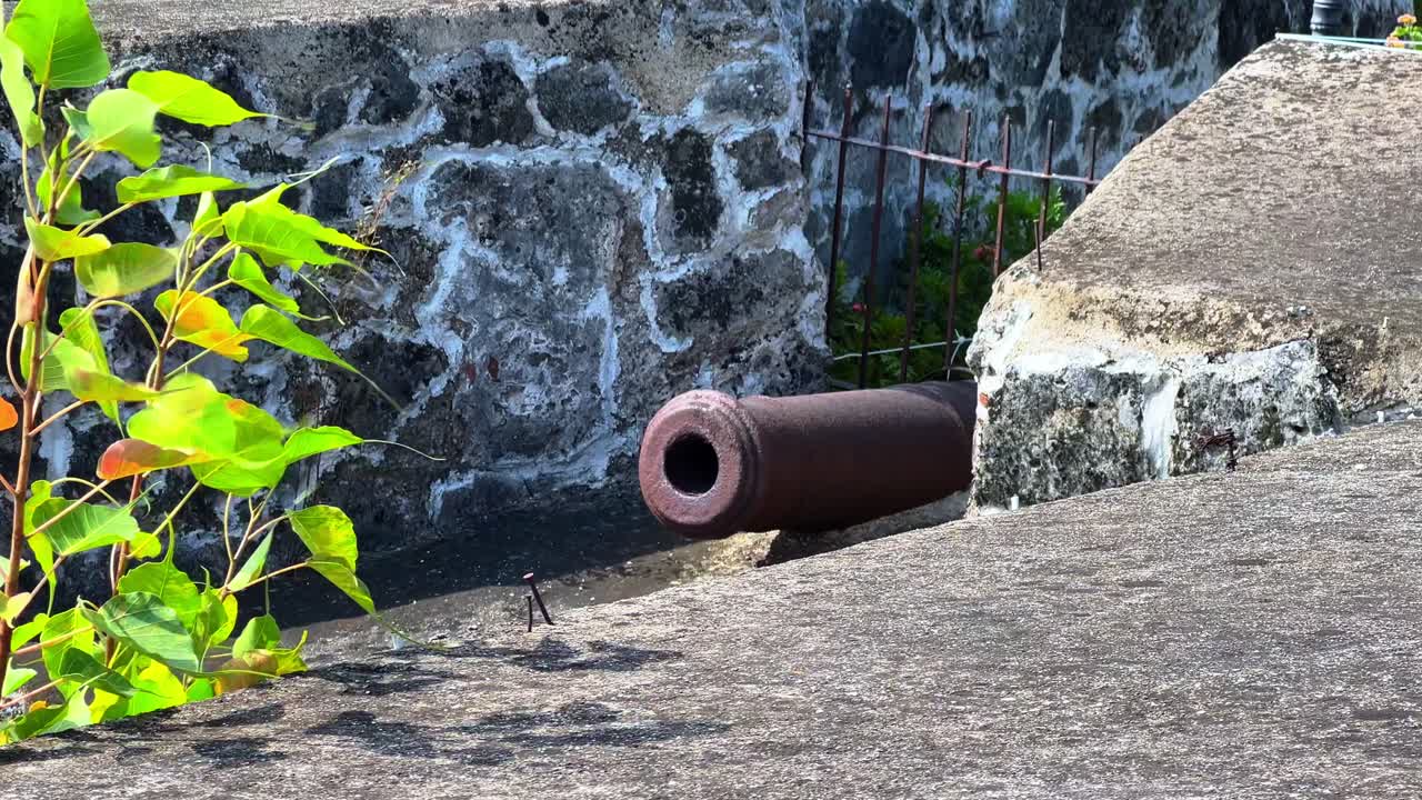 Aged iron cannon in weathered stone fort — great for historical, colonial, war, or heritage-themed projects and documentaries