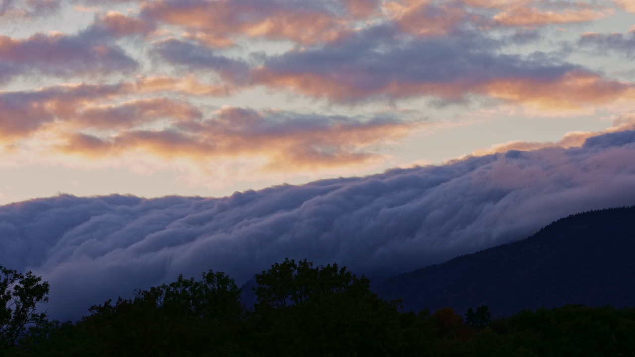 Breathtaking autumn timelapse in Verbier, Switzerland. Clouds drift over colorful Alpine forests and peaks, capturing the serene passage of time in the Swiss Alps. Perfect for nature projects.