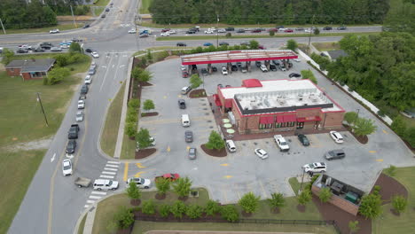 cars wrapped all around a gas station needing gas, during a gas shortage