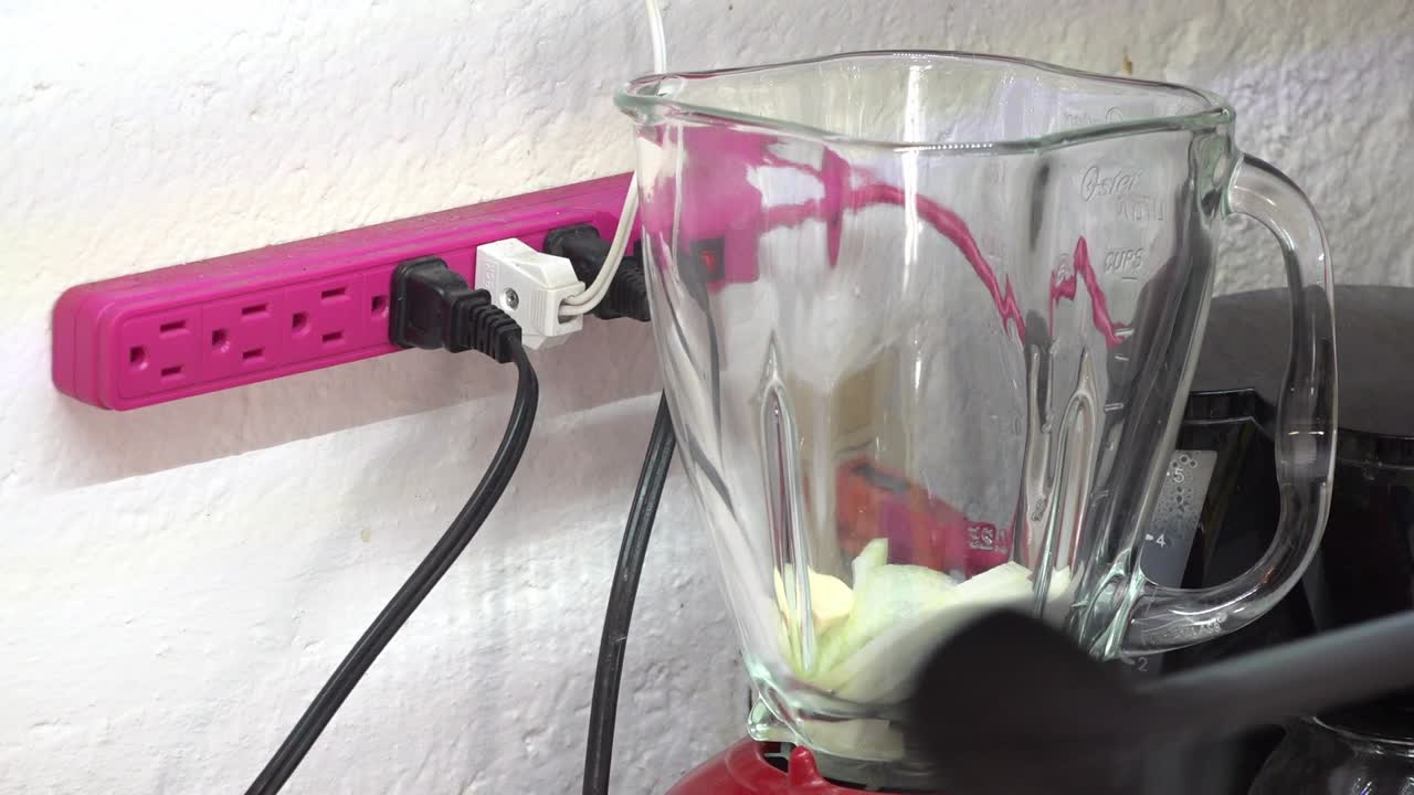 Adding onion, tomatoes and garlic to a blender