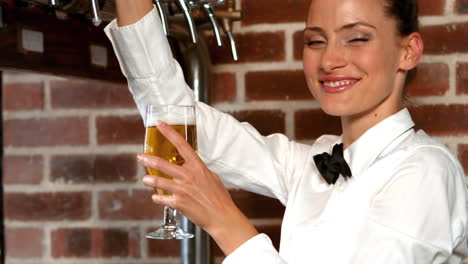 barmaid pulling a glass of beer