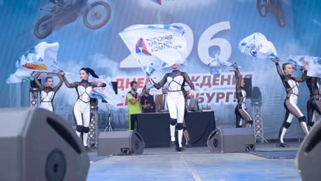 flag-waving dancers on stage