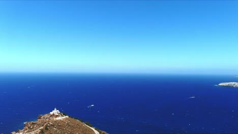 aerial 4k blue sea and sky top view over akrotiri leuchtturm in santorini greece