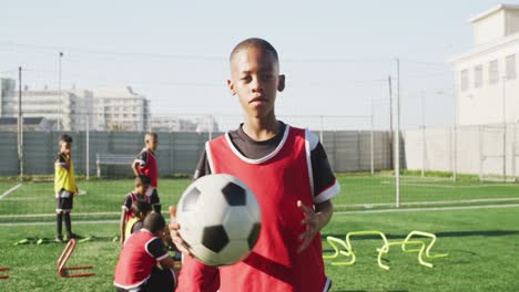 african american soccer kid exercising in a sunny day