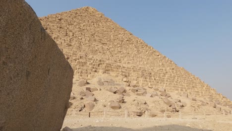 looking up from beside stone block to pyramid of menkaure