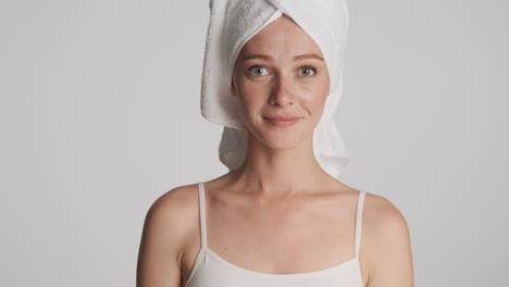 caucasian woman wearing towel on her head.