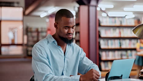 man experiencing neck pain in a library