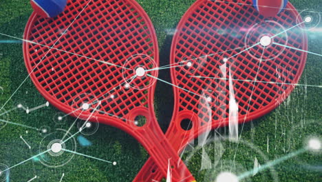 red plastic rackets being shown crossing on green turf, with digital nodes linking across surface