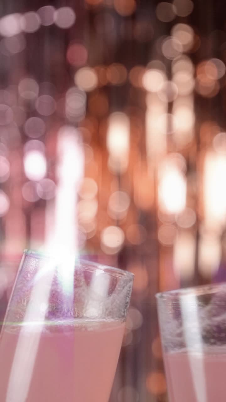 お祝いのボケライトでシャンパングラスを乾杯