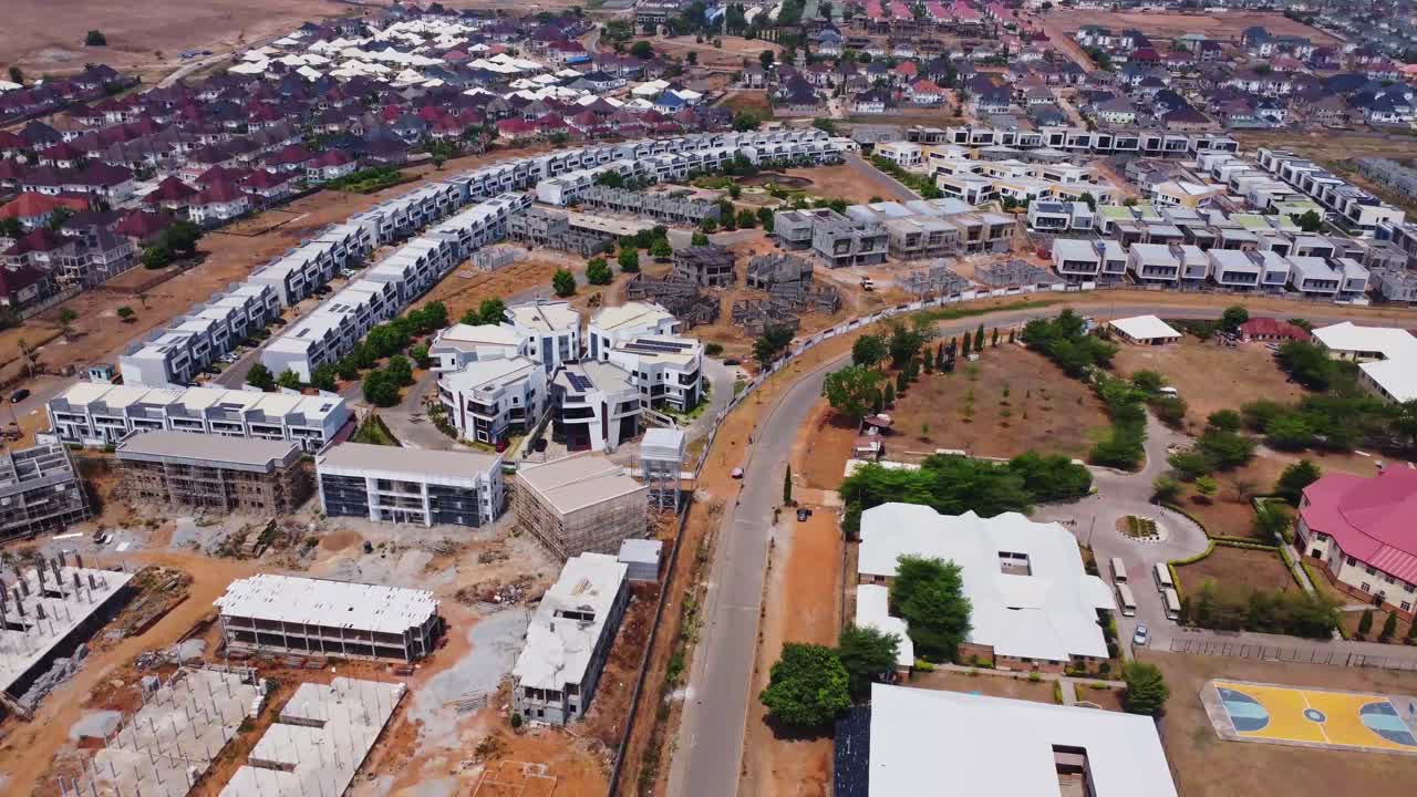 jib down of a beautiful suburban neighborhood with a new block being developed at Godab Estate in Abuja, Nigeria