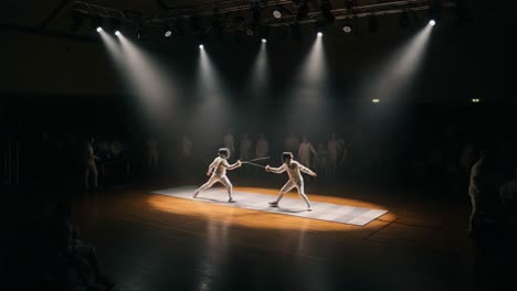 dramatic fencing duel in spotlight: two competitors engage in an intense match on a dimly lit stage, surrounded by an enthusiastic audience