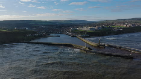 wide angle drone shot of whitby town at high tide north yorkshire uk