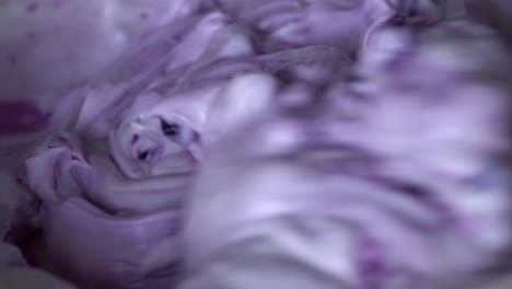 close up view of creamy blueberry filling being stirred with a metallic spoon