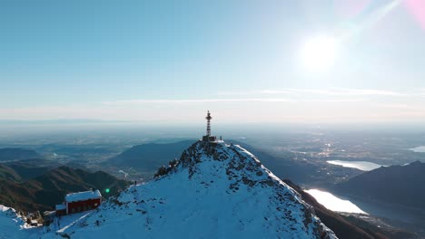 aerial view of cross of punta cermenati on snow covered peak at monte resegone