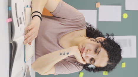 Vertical-video-of-Books-and-unhappy-Female-student.