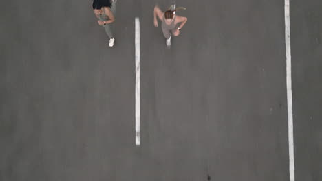 two women jogging on a parking lot